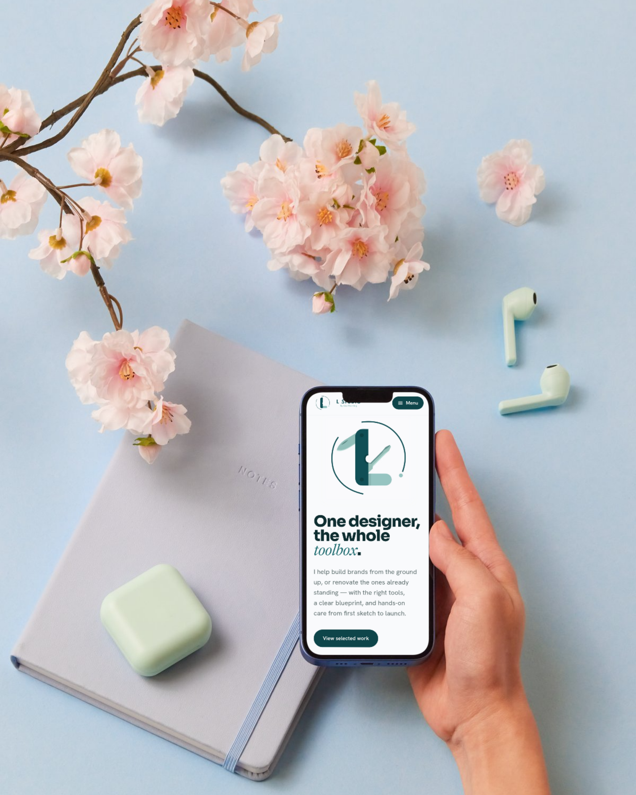 L Studio mobile homepage displayed in a lifestyle setting